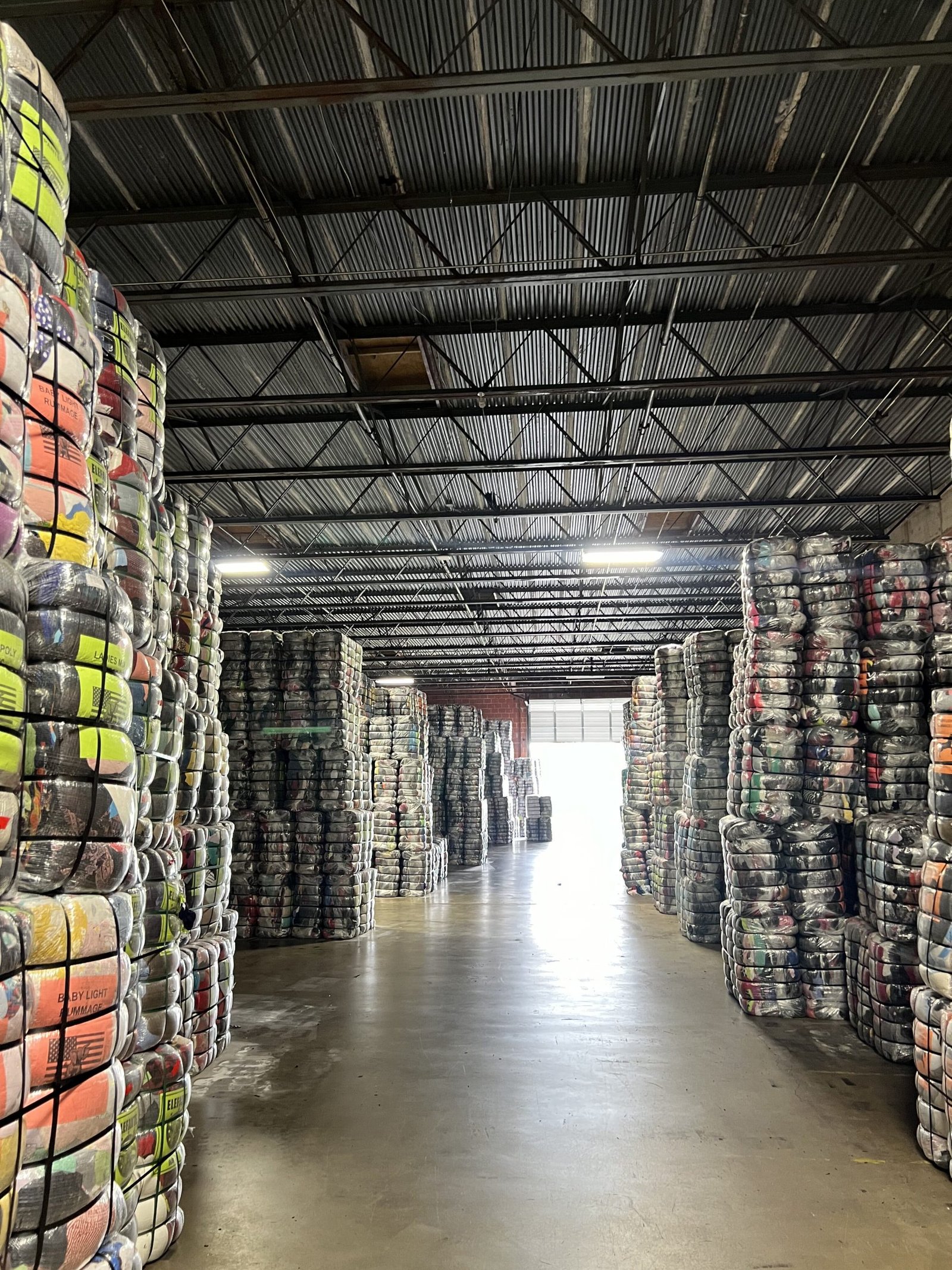 US Dynamics inventory room with sorted used clothing bales