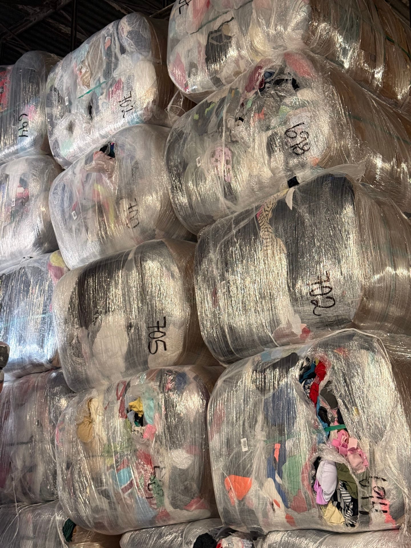 Credential rags bales at US Dynamics warehouse — original-wrap, lot-numbered, untouched