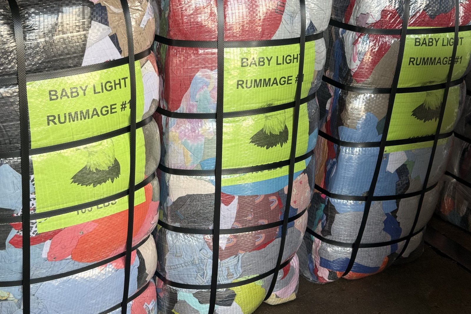 Graded and labeled Baby Light Rummage used clothing bales at the US Dynamics Houston warehouse