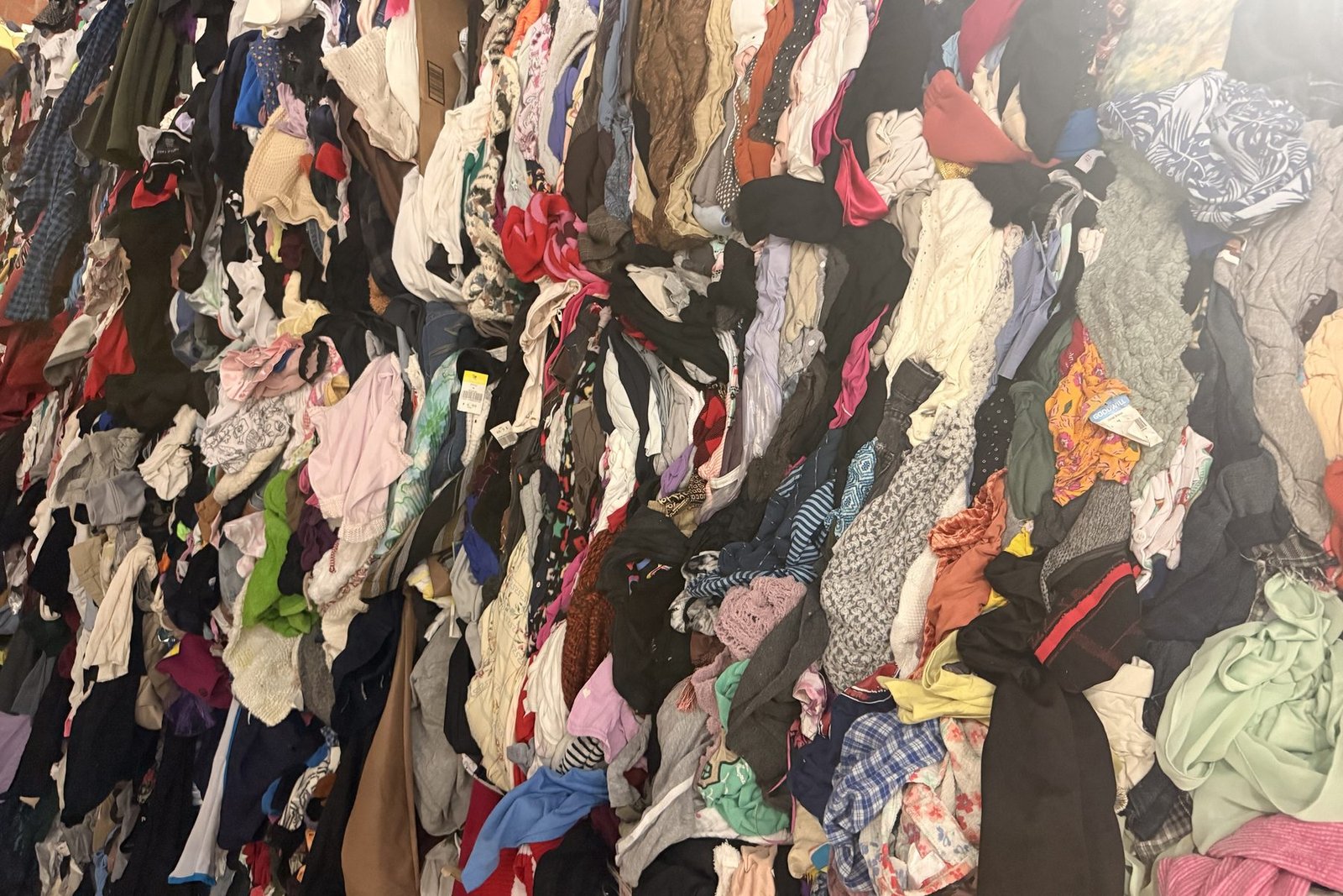 Wall of institutional mixed rags and credential clothing at the US Dynamics Houston facility