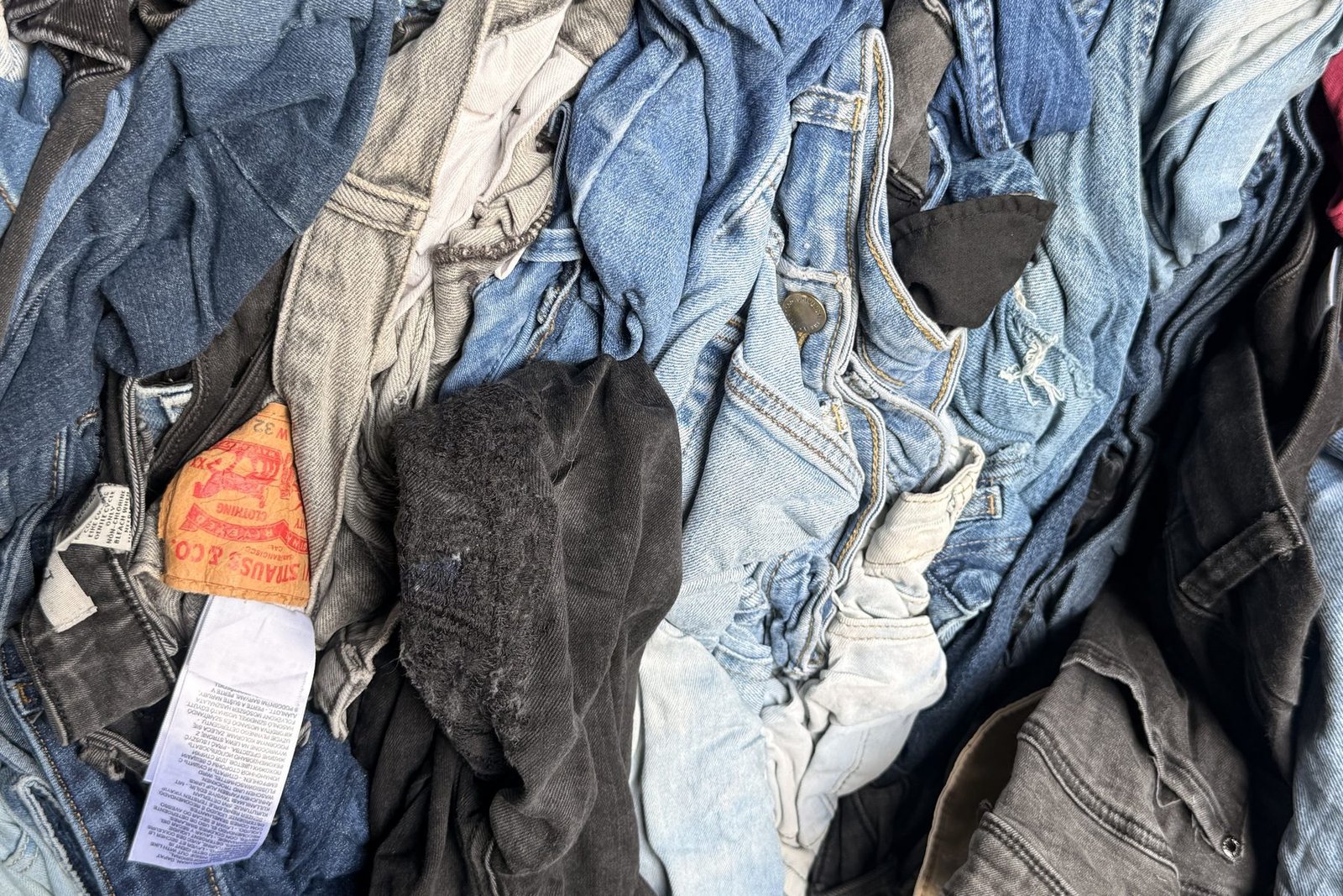 Mixed denim jeans and jackets sorted for textile recycling at the US Dynamics Houston facility